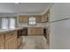 Kitchen with island, black appliances, wooden cabinets, and tile countertops at 3427 Brunswick Ave, Indianapolis, IN 46227