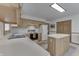 Kitchen with island, black appliances, wooden cabinets, and white counter tops at 3427 Brunswick Ave, Indianapolis, IN 46227