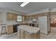 Bright kitchen with island, black appliances, wooden cabinets, and tile countertops at 3427 Brunswick Ave, Indianapolis, IN 46227