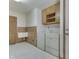 Bright laundry room with washer, dryer, cabinets, and vintage sink at 3427 Brunswick Ave, Indianapolis, IN 46227