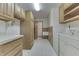 This laundry room features plenty of cabinet space and a utility sink, making chores easy at 3427 Brunswick Ave, Indianapolis, IN 46227