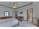Bright main bedroom with ceiling fan, trim details, and an ensuite bathroom at 3427 Brunswick Ave, Indianapolis, IN 46227