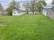Spacious backyard featuring lush green grass and a white detached garage at 3434 Forrest Ter, Anderson SE, IN 46013
