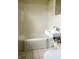 Simple bathroom with tiled walls, a modest sink, and a clean toilet, ensuring functionality and ease of maintenance at 3434 Forrest Ter, Anderson SE, IN 46013