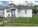 A quaint house with white siding, a dark roof, concrete steps, and a simple, functional front entrance at 3434 Forrest Ter, Anderson SE, IN 46013