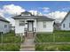 A charming house with white siding, concrete stairs, and a well-kept lawn, reflecting classic curb appeal at 3434 Forrest Ter, Anderson SE, IN 46013