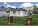 Charming home featuring a tidy yard enclosed by a decorative metal fence and quaint brick pillars at 3434 Forrest Ter, Anderson SE, IN 46013