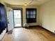 A bright room featuring hardwood floors and a view through the front door to the outside at 3434 Forrest Ter, Anderson SE, IN 46013