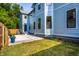 A beautiful light blue two-story house showcasing the backyard patio and grassy area at 3868 N Park Ave, Indianapolis, IN 46205