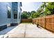 A beautiful light blue two-story house showcasing the backyard patio and fence at 3868 N Park Ave, Indianapolis, IN 46205