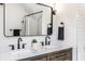 Close-up of a bathroom featuring a double vanity with black faucets and a framed mirror at 3868 N Park Ave, Indianapolis, IN 46205