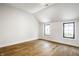 Stylish bedroom showcasing beautiful wood floors, white walls and trim, and two windows at 3868 N Park Ave, Indianapolis, IN 46205