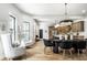 Bright, open dining area featuring a modern chandelier and seamless flow to the kitchen at 3868 N Park Ave, Indianapolis, IN 46205