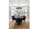 Well-lit dining area with stylish chairs and a modern light fixture with large windows at 3868 N Park Ave, Indianapolis, IN 46205