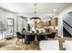 Elegant dining room open to the kitchen with modern lighting and seating at 3868 N Park Ave, Indianapolis, IN 46205