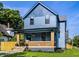 Charming two-story home featuring a covered front porch with brick supports and a well-maintained lawn at 3868 N Park Ave, Indianapolis, IN 46205
