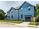 View of a beautiful blue two-story house with a well-kept lawn on a sunny day at 3868 N Park Ave, Indianapolis, IN 46205