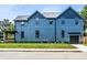 View of a beautiful blue two-story house with a well-kept lawn on a sunny day at 3868 N Park Ave, Indianapolis, IN 46205