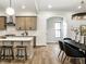 Modern kitchen with stainless steel appliances, island seating, and an open dining area at 3868 N Park Ave, Indianapolis, IN 46205