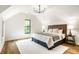 Bright main bedroom with vaulted ceiling, stylish bed frame, and soft lighting at 3868 N Park Ave, Indianapolis, IN 46205
