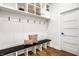 Well-organized mudroom with bench seating, coat hooks, overhead basket storage, and a door at 3868 N Park Ave, Indianapolis, IN 46205