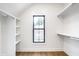 Bright, modern walk-in closet featuring custom shelving, clothes rods, and a window for natural light at 3868 N Park Ave, Indianapolis, IN 46205