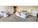 Bright bedroom with a queen bed, lamps, and an accent chair with an ottoman at 4000 N Meridian St # Apt 15J, Indianapolis, IN 46208