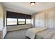 Bright bedroom features large window, blinds, and a double door closet with neutral decor at 4000 N Meridian St # Apt 15J, Indianapolis, IN 46208