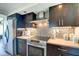 Well-equipped kitchen featuring sleek cabinetry, stainless steel appliances, and stylish tile backsplash at 4000 N Meridian St # Apt 15J, Indianapolis, IN 46208