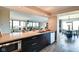 A modern kitchen featuring stainless appliances, a breakfast bar, and an open view to the living area at 4000 N Meridian St # Apt 15J, Indianapolis, IN 46208