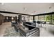 Modern living room with stylish seating and glass windows showcasing the outdoor scenery and natural light at 4000 N Meridian St # Apt 15J, Indianapolis, IN 46208