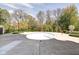 An in-ground pool with surrounding patio and mature trees at 4000 N Meridian St # Apt 15J, Indianapolis, IN 46208