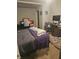 Bedroom with a queen bed and cluttered desk area at 4006 Kenneth Ave, Indianapolis, IN 46226