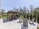 Landscaped backyard with a gazebo featuring comfortable seating and an outdoor living area at 4037 Hazy Ln, Greenwood, IN 46142