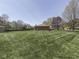 Wide backyard view of lush lawn, storage shed, patio with gazebo, and brick home at 4037 Hazy Ln, Greenwood, IN 46142