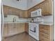Well-lit kitchen featuring wood cabinets, modern appliances, and hardwood flooring at 4037 Hazy Ln, Greenwood, IN 46142