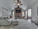 Spacious living room features a brick fireplace, vaulted ceilings, neutral colors, and ample natural light at 4037 Hazy Ln, Greenwood, IN 46142