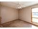 This is a bedroom with carpet, a window and a ceiling fan at 4651 Monterey Dr, Columbus, IN 47203