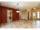 Dining area featuring tile floors and rustic red accent walls, enhancing the interior design at 4651 Monterey Dr, Columbus, IN 47203
