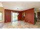 Open dining area with tile floor, sliding door access to the deck, and rustic red accent wall at 4651 Monterey Dr, Columbus, IN 47203