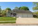 Charming single-story home featuring a three-car garage, covered porch, and well-manicured lawn at 4651 Monterey Dr, Columbus, IN 47203