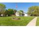 Expansive front yard with American flag and flower bed showcasing the home's curb appeal at 4651 Monterey Dr, Columbus, IN 47203