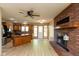Open kitchen with a center island, brick fireplace, and wood floors, perfect for entertaining at 4651 Monterey Dr, Columbus, IN 47203