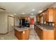 Well-equipped kitchen with an island, stainless steel appliances, and warm wood cabinets at 4651 Monterey Dr, Columbus, IN 47203
