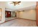 Open concept living room with carpet, vaulted ceiling, and view to tile-floored dining area at 4651 Monterey Dr, Columbus, IN 47203
