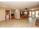 Open-concept living room featuring light wood floors and an eat-in kitchen at 4651 Monterey Dr, Columbus, IN 47203