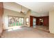 Bright living room with large windows, neutral carpet, and vaulted ceiling, showcasing open layout at 4651 Monterey Dr, Columbus, IN 47203
