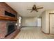 Spacious living room features a brick fireplace, wood-look flooring, and ceiling fan at 4651 Monterey Dr, Columbus, IN 47203