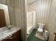Bathroom with floral wallpaper, a bathtub, a shower with curtain, sink, and toilet at 4726 Breckenridge Dr, Columbus, IN 47203