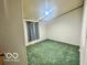 Simple bedroom with dark carpet, light-colored walls, and a window with curtains at 4726 Breckenridge Dr, Columbus, IN 47203